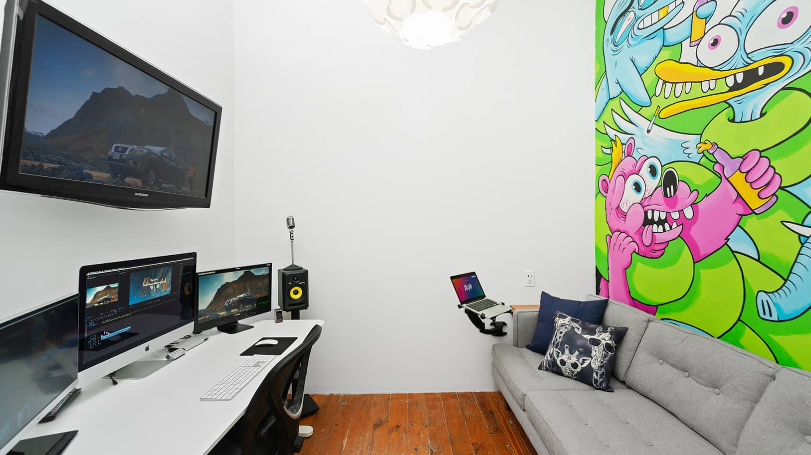 Post-production suite equipment in front of sofa and grafitti-painted wall | Think Twice studio