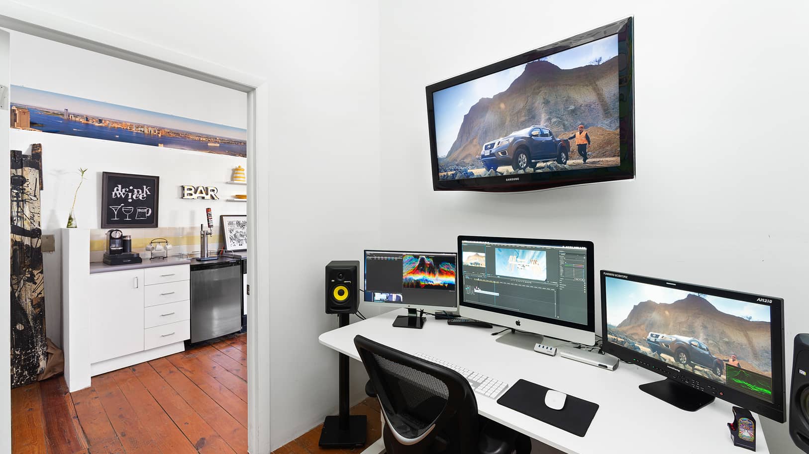 Post-production suite equipment and kitchen in the background | Think Twice studio